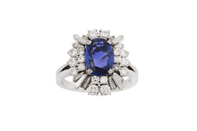 Lot 1294 - A sapphire and diamond dress ring, circa 1965