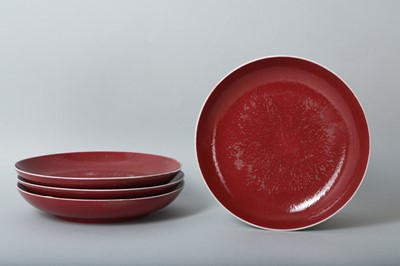 Lot 80 - A SET OF FOUR CHINESE COPPER RED-GLAZED DISHES.