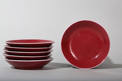 Lot 81 - A SET OF SIX CHINESE COPPER-RED GLAZED SAUCER DISHES.