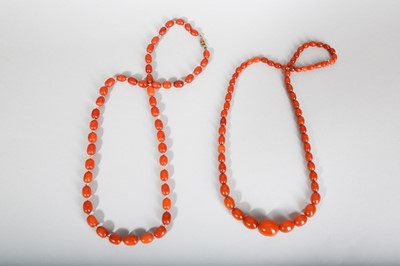 Lot 104 - TWO AMBER BEAD NECKLACES.
