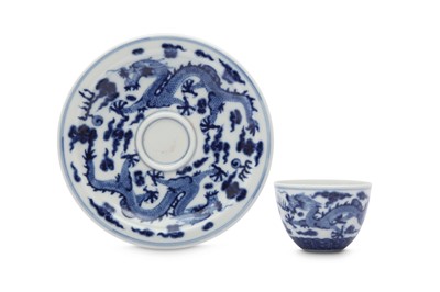 Lot 629 - A CHINESE BLUE AND WHITE 'DRAGON' CUP AND SAUCER.