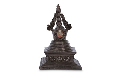 Lot 762 - A WHITE METAL STUPA.