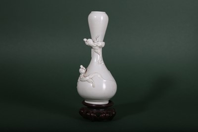 Lot 10 - A CHINESE WHITE-GLAZED GARLIC MOUTH 'DRAGON' VASE.