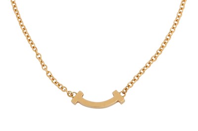 Lot 1264 - Tiffany & Co. | A gold 'Tiffany T Smile' bracelet