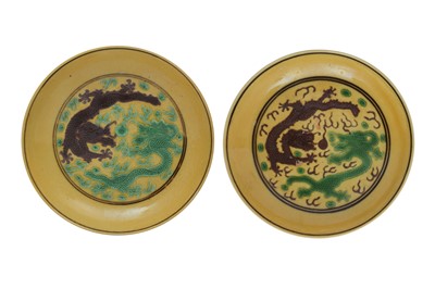 Lot 296 - A NEAR PAIR OF CHINESE YELLOW-GROUND GREEN AND AUBERGINE 'DRAGON' DISHES.