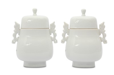 Lot 456 - A PAIR OF CHINESE WHITE-GLAZED ARCHAISTIC VASES AND COVERS.