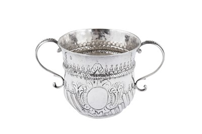 Lot 446 - A Queen Anne Britannia standard silver porringer, London 1713 by Nathaniel Lock, additionally struck AR crowned
