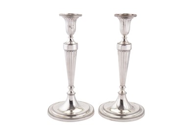 Lot 411 - A pair of George III sterling silver candlesticks, London 1781 by John Scofield (reg. 13th Jan 1778)