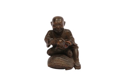 Lot 325 - A WOOD NETSUKE OF A FARMER.
