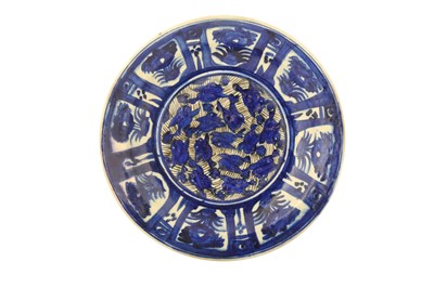 Lot 80 - A LARGE LATE QAJAR BLUE AND WHITE POTTERY CHARGER