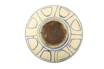 Lot 80 - A LARGE LATE QAJAR BLUE AND WHITE POTTERY CHARGER