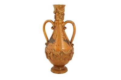 Lot 94 - A BROWN AND YELLOW-SPLASHED AMBER-GLAZED ÇANAKKALE POTTERY EWER