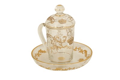Lot 187 - A GILT CLEAR BACCARAT GLASS LIDDED TEACUP AND SAUCER WITH ROYAL EGYPTIAN CROWN INSIGNIA
