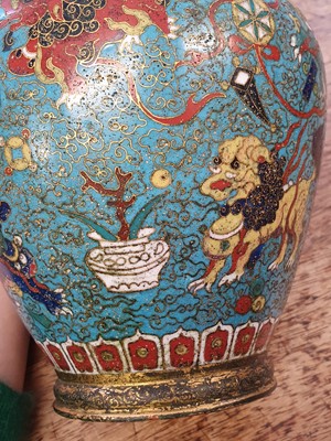 Lot 35 - A CHINESE GILT BRONZE AND CLOISONNÉ ENAMEL 'LION DOGS' BUDDHIST LONGEVITY VASE, BUMPA.