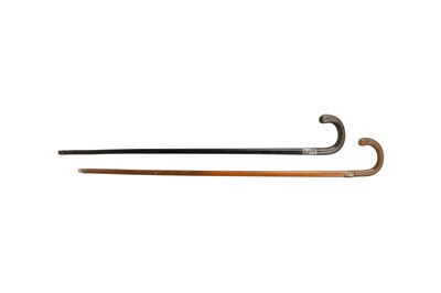 Lot 542 - λ TWO RHINOCEROS HORN HANDLED WALKING STICKS.