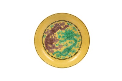 Lot 243 - A CHINESE YELLOW-GLAZED 'DRAGON' DISH.