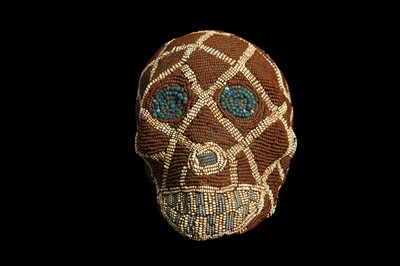 Lot 83 - AN EARLY 20TH CENTURY BAMILEKE TRIBE ANCESTOR SKULL WITH BEADED DECORATION