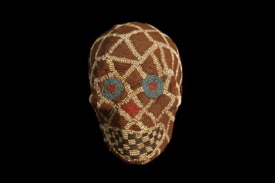 Lot 84 - AN EARLY 20TH CENTURY BAMILEKE TRIBE ANCESTOR SKULL WITH BEADED DECORATION