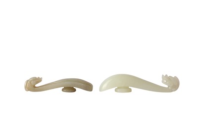Lot 860 - TWO CHINESE PALE CELADON JADE DRAGON BELT HOOK.