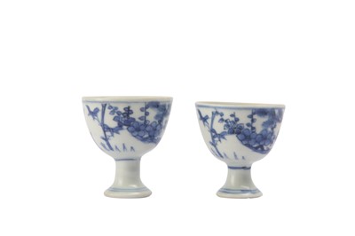 Lot 90 - A PAIR OF SMALL CHINESE BLUE AND WHITE ‘THREE FRIENDS’ STEM CUPS.