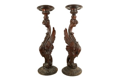 Lot 320 - A LARGE PAIR OF 19TH CENTURY ITALIAN CARVED WOOD GRIFFIN TORCHERE STANDS