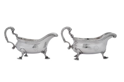 Lot 509 - A near pair of George II/III sterling silver sauceboats, one London 1764 by William Grundy