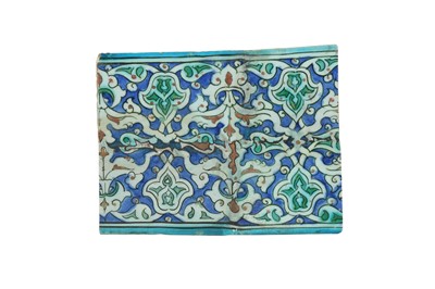 Lot 279 - AN IZNIK POTTERY TILE FRAGMENT WITH ARABESQUE AND SPLIT PALMETTE SCROLLS