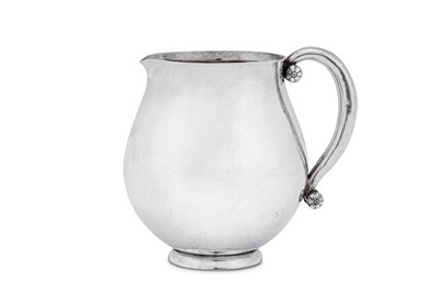 Lot 464 - An early 20th century Danish sterling silver cream jug, Copenhagen by Georg Jensen, import marks for London 1939