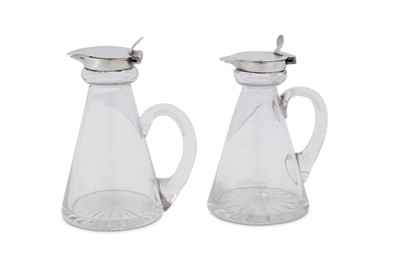 Lot 447 - An assembled pair of George V sterling silver mounted glass whiskey noggins