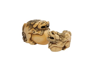 Lot 303 - λ TWO IVORY SHISHI DOG NETSUKE.