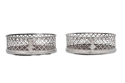 Lot 520 - An unusual pair of George III sterling silver wine coasters, London 1768 by Thomas and William Chawner (active circa 1759-73)