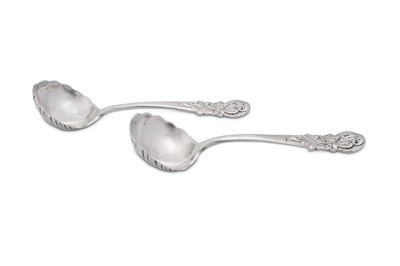 Lot 373 - A pair of George II sterling silver cast sauce ladles, London 1750 by Peter Taylor (reg. 11th Nov 1740)