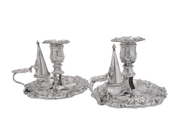 Lot 494 - A pair of George III and George IV sterling silver chambersticks, Sheffield 1814/27 by James Kirkby, Waterhouse & Co and Waterhouse, Hodson & Co respectively