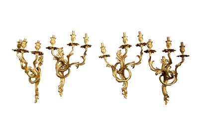 Lot 534 - A SET OF FOUR LOUIS XV GILT BRONZE THREE LIGHT WALL LIGHTS, 20TH CENTURY