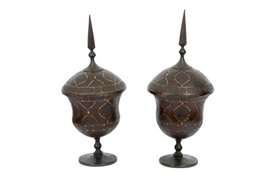 Lot 302 - A PAIR OF QAJAR GOLD-DAMASCENED STEEL LIDDED VASES