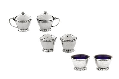 Lot 500 - An Edward VIII 'Arts and Crafts' sterling silver six-piece cruet set, Birmingham 1936 by Liberty and Co