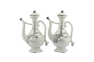 Lot 28 - A PAIR OF CHINESE BLUE AND WHITE EWERS AND COVERS.