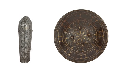 Lot 388 - A QAJAR ENGRAVED AND GOLD-DAMASCENED STEEL SHIELD AND ARM GUARD (BAZUBAND)