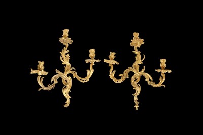 Lot 106 - A PAIR OF 19TH CENTURY FRENCH GILT BRONZE ROCOCO STYLE THREE LIGHT WALL APPLIQUES