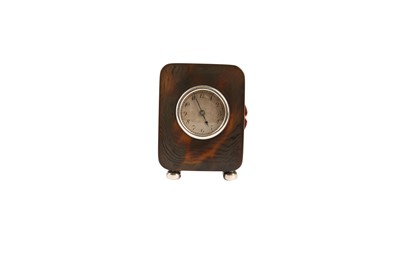 Lot 303 - AN EARLY 20TH CENTURY TORTOISESHELL AND SILVER MINIATURE TRAVEL CLOCK BY THE GENEVA CLOCK CO.