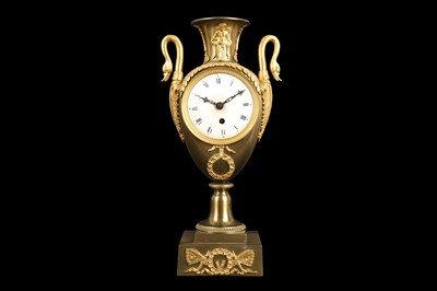 Lot 293 - AN EARLY 19TH CENTURY FRENCH EMPIRE PERIOD GILT BRONZE URN CLOCK