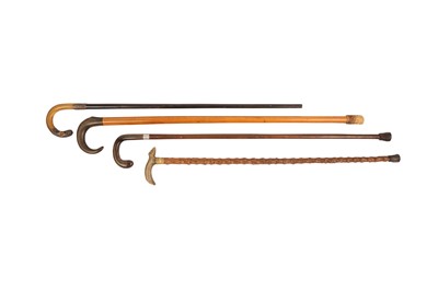 Lot 577 - λ FOUR WALKING STICKS WITH RHINOCEROS HORN HANDLES.