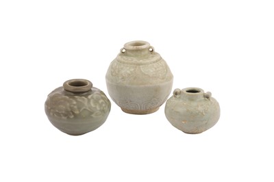 Lot 665 - THREE CELADON GLAZED JARLETS.