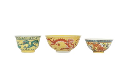 Lot 241 - THREE CHINESE YELLOW-GROUND 'DRAGON' BOWLS.