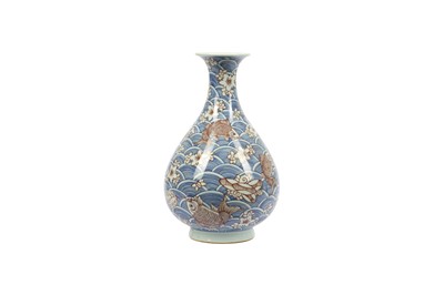 Lot 558 - A CHINESE BLUE AND WHITE ANDUNDERGLAZE RED 'CARPS' BOTTLE VASE.