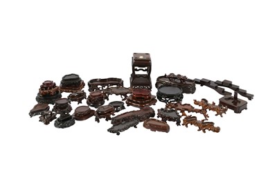 Lot 407 - A COLLECTION OF FORTY-ONE CHINESE WOOD STANDS.