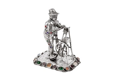 Lot 40 - A late 19th century / early 20th century German silver and paste set model of a man sharpening a knife, Hanau circa 1900 by B. Neresheimer & Sohne
