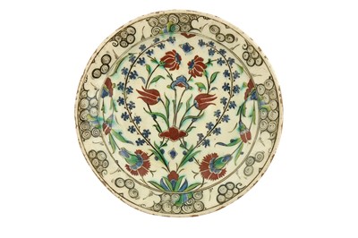 Lot 501 - A LARGE INTACT IZNIK POTTERY DISH WITH QUATRE FLEURS DESIGN