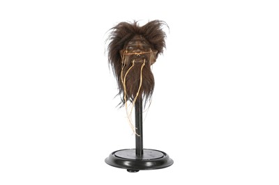 Lot 34 - A FAUX SHRUNKEN HEAD ON STAND
