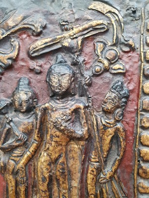 Lot 186 - A NEPALESE GILT-BRONZE PLAQUE FRAGMENT.